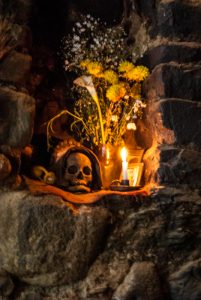 Offering of Candle and Flowers for Skull at Home (Photo: Walter Coraza. M)
